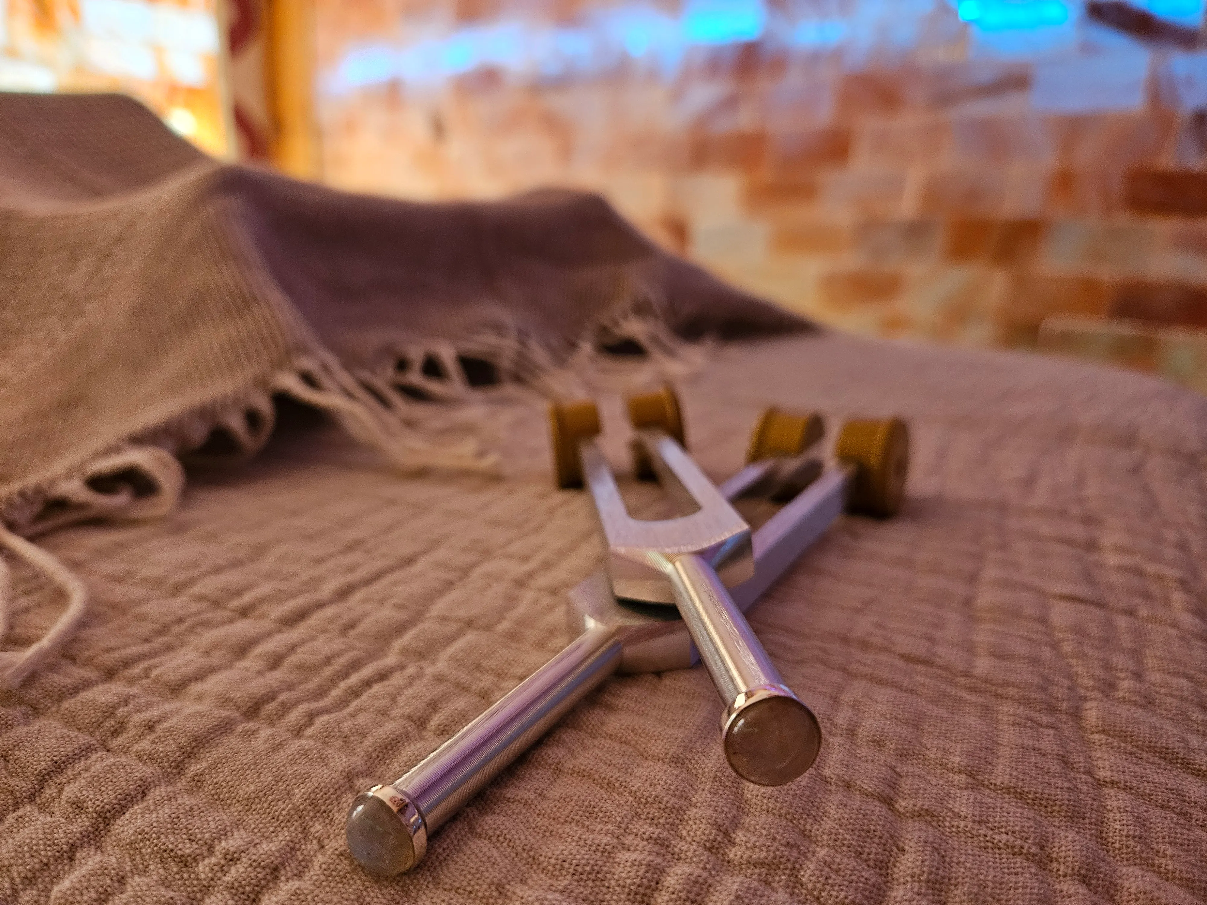 Acutonics® tuning forks resting on soft linen