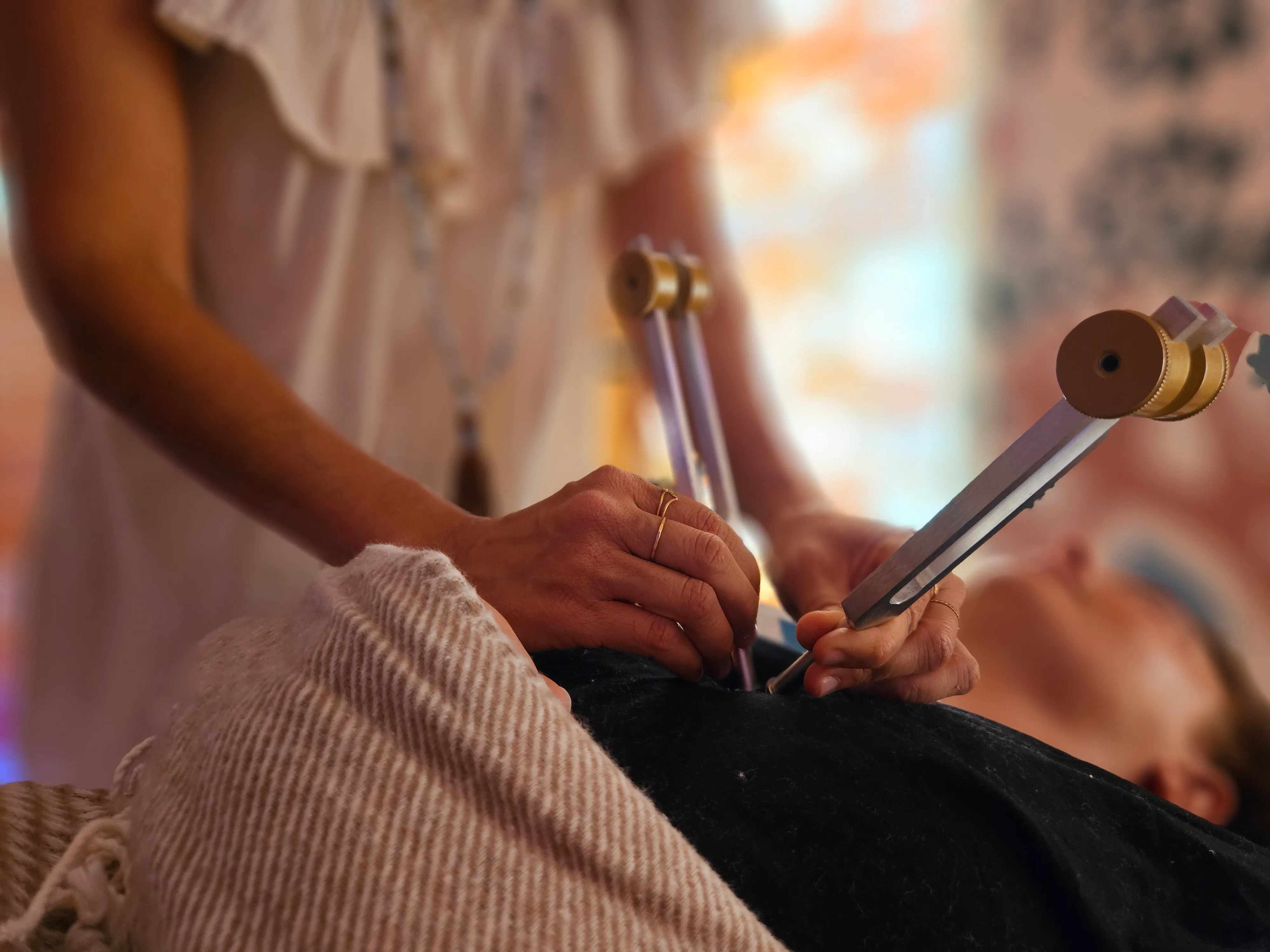 Jarin Wadiwalla applying a tuning fork during an Acutonics® session